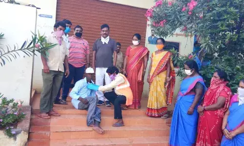 District Collector L Sharman Chavan attending a mentally ill person in Achampet on Friday