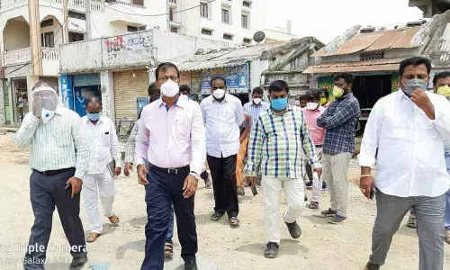 District Collector Vinay Krishna Reddy along with municipal officials and people’s representatives examining the road expansion works in Suryapet town on Saturday