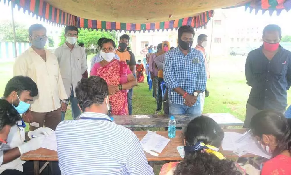 People waiting to give their samples for Covid tests in Srikakulam