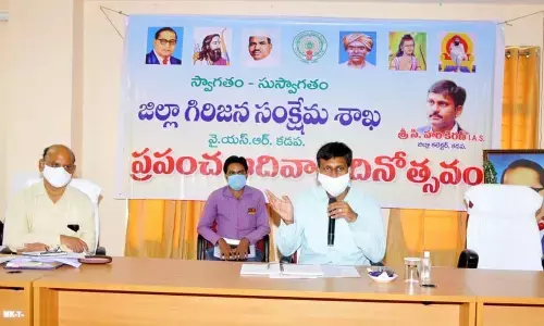 District Collector Ch Harikiran addressing a programme held on the occasion of the International Tribal Day in Kadapa on Sunday