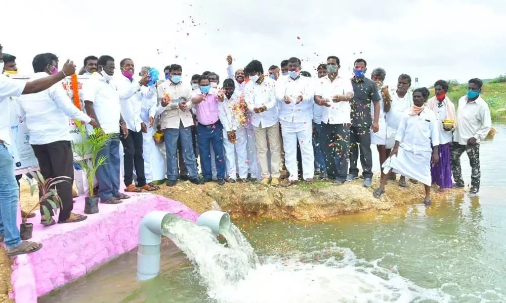Agriculture Minister Singireddy Niranjan Reddy watching the water flowing from Jurala canal after inaugurated lift motor at Khan Lake