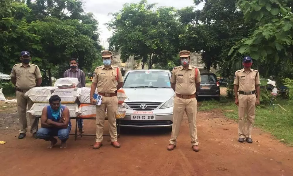 Police producing seized ganja, car and the accused before the media in Bhadrachalam on Sunday