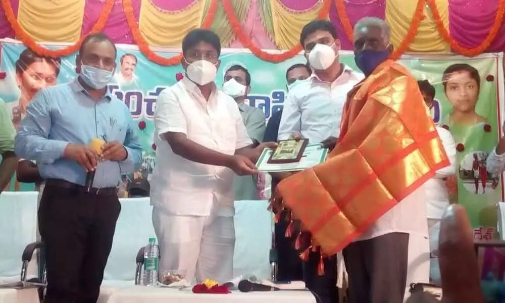Minister Audimulapu Suresh and Joint Collector TS Chetan distributing assets to tribal people in Dornala on Sunday