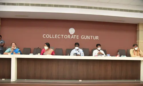 Collector I Samuel Anand Kumar addressing a review meeting in Guntur on Monday. Joint Collector A S Dinesh Kumar and GMC Commissioner Challa Anuradha are also seen.
