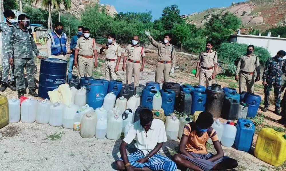 (File photo) Police with seized ID liqour manfacturing material and arrested accused  in Tirupati