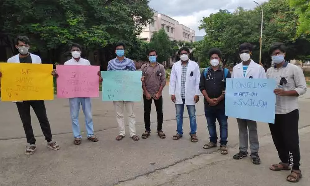 APJUDA Tirupati unit members displaying posters in support of their demands as part of their agitation
