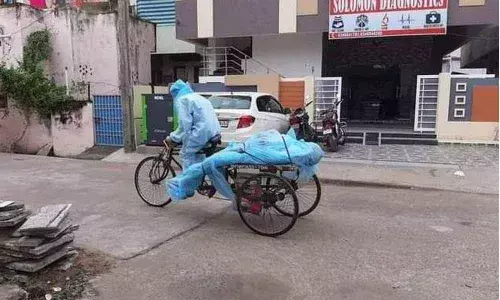 Body of Covid-19 patient being shifting on a cycle-rickshaw in Bapatla on Wednesday