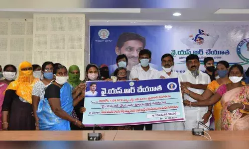 Deputy Chief Minister Amzath Basha distributing cheques to the beneficiaries under the YSR Cheyutha scheme in Kadapa on Wednesday