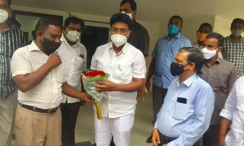 AKTPU OSD Dr KVN Raju and staff thanking Minister Dr A Suresh in Ongole on Wednesday