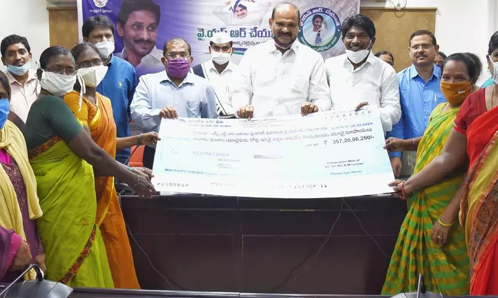 Krishna District Collector Md Imtiaz, MLAs K Parthasarathi and K Rakshana Nidhi handing over cheques to beneficiaries in Vijayawada on Wednesday