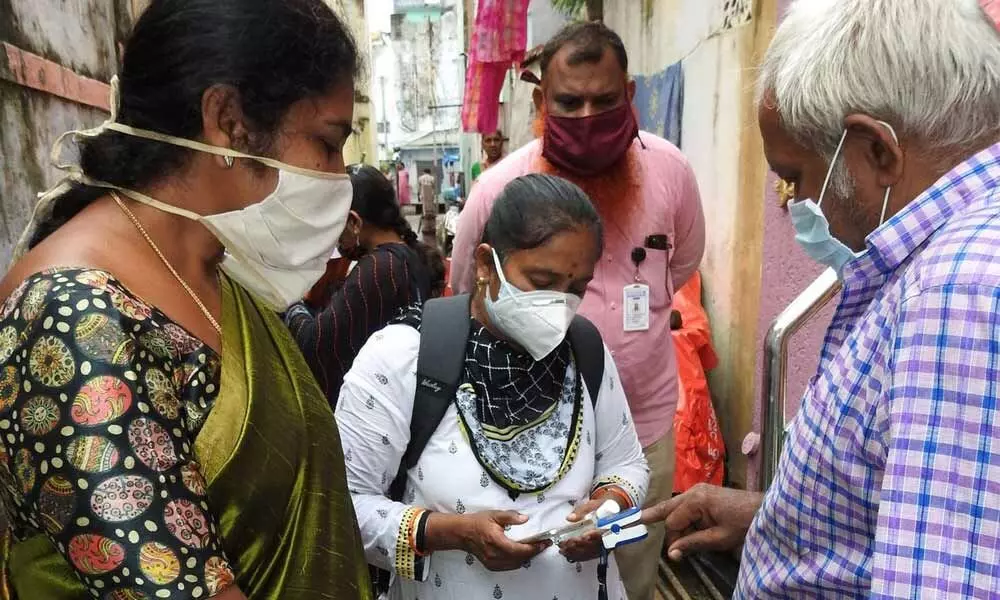 GMC Commissioner Challa Anuradha inspecting door-to-door pulse oximeter tests in Guntur on Wednesday