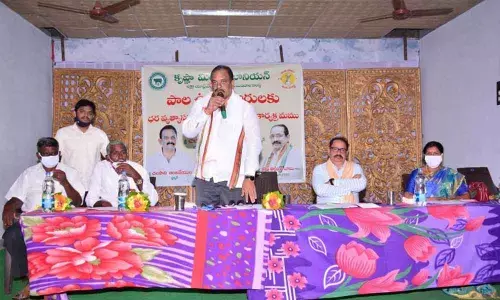 Vijaya Dairy Chairman Chalasani Anjaneyulu speaking in the meeting held at Lakshmipuram on Friday