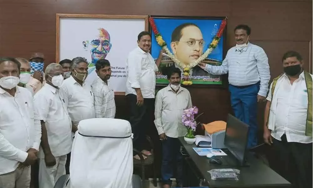 Minister for Social Welfare Pinepe Viswaroop garlanding Dr BR Ambedkar’s portrait at RDO office in Amalapuram on Friday