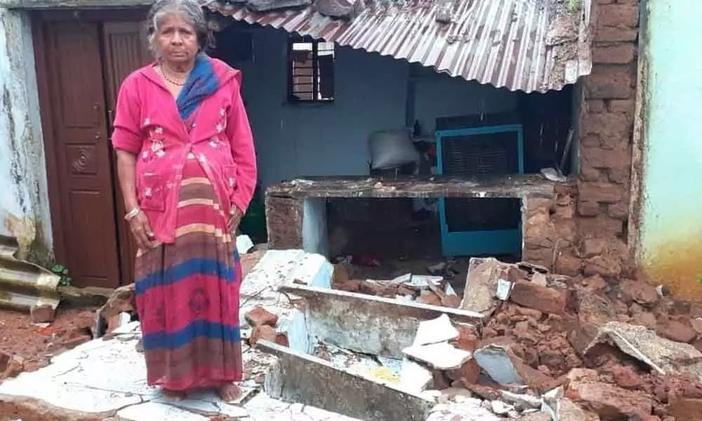 Woman calls for help as rain shreds her house
