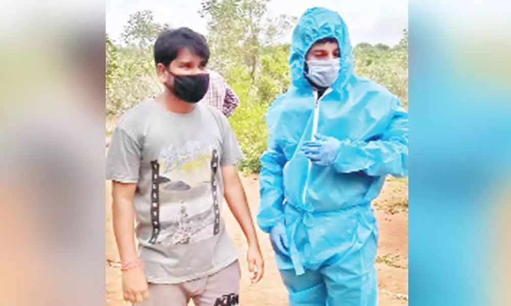 Uday Kumar wearing PPE Kit before participating in the funeral of BJP leader D Kutumba Rao in Yellandu