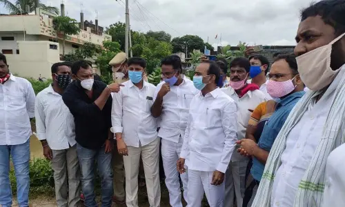 Health Minister E Rajendar inspecting low lying areas drowned in Huzurabad mandal on Monday