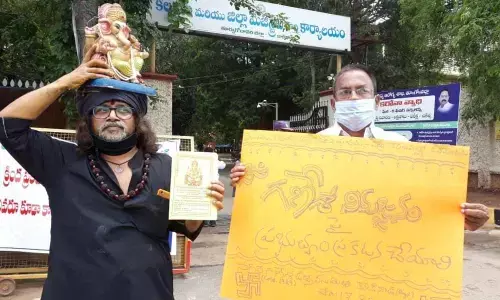 Nagar Ganesh Utsav Samiti leaders Dusarlapudi Ramana Raju and Duvvuri Subramanayam staging a dharna