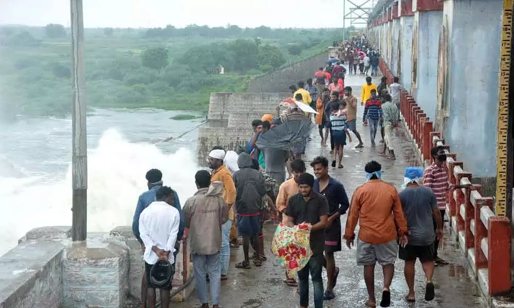 Throwing Covid norms to winds, enthusiasts rush to watch the release of floodwater at Musi project in Nakrekal Kathapalli mandal in Nalgonda district on Monday 	Photo: Mucharla Srinivas