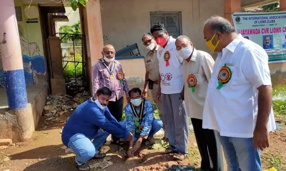 CVR Lions Club members planting saplings at the Municipal Corporation MK Baig School in Vijayawada on Tuesday