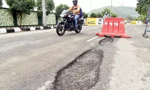 Potholes dot several parts of Visakhapatnam, giving a tough time for commuters to wade through