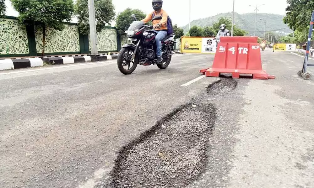 Potholes dot several parts of Visakhapatnam, giving a tough time for commuters to wade through