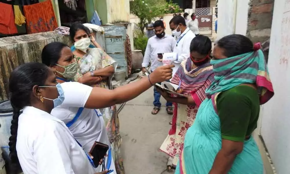 GMC Commissioner Challa Anuradha inspecting door-to-door temperature testing in Guntur on Wednesday