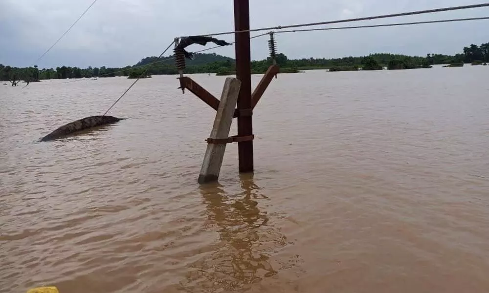 A 33 KV line seen touching the floodwater in Devipatnam mandal in East Godavari district on Wednesday