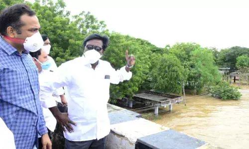 Transport Minister Puvvada Ajay Kumar inspecting Munneru riverbanks in Khammam on Friday. District Collector RV Karnan also seen