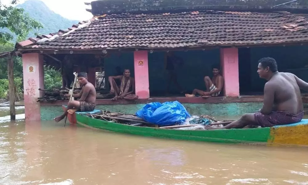 Villagers are moving on boats in the flood-hit Devipatnam mandal in East Godavari