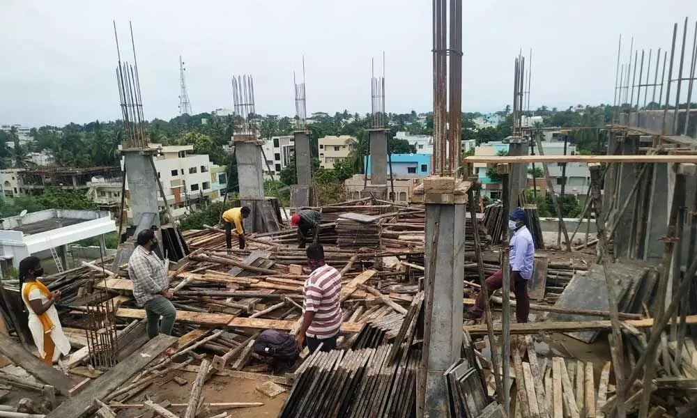 Municipal Corporation officials demolishing unauthorised constructions in Rajamahendravaram on Sunday