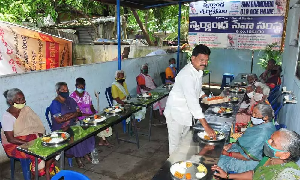 Swarnandhra Seva Samsta founder Dr Gubbala Rambabu serving  food to inmates of old age home