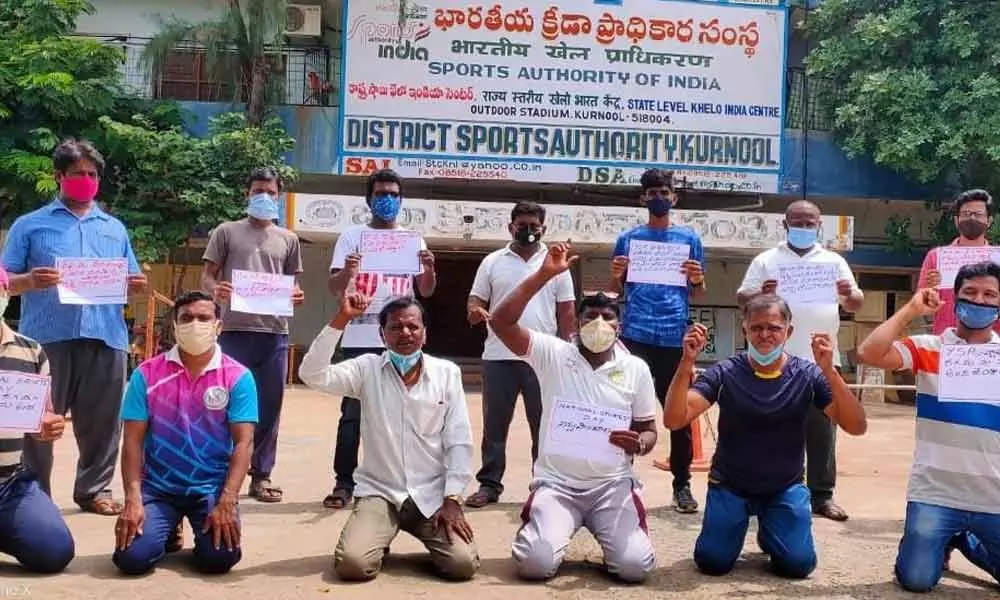 Members of Private Schools Physical Education Teachers Association staging a protest in front of District Sports Authority Stadium in Kurnool on Sunday