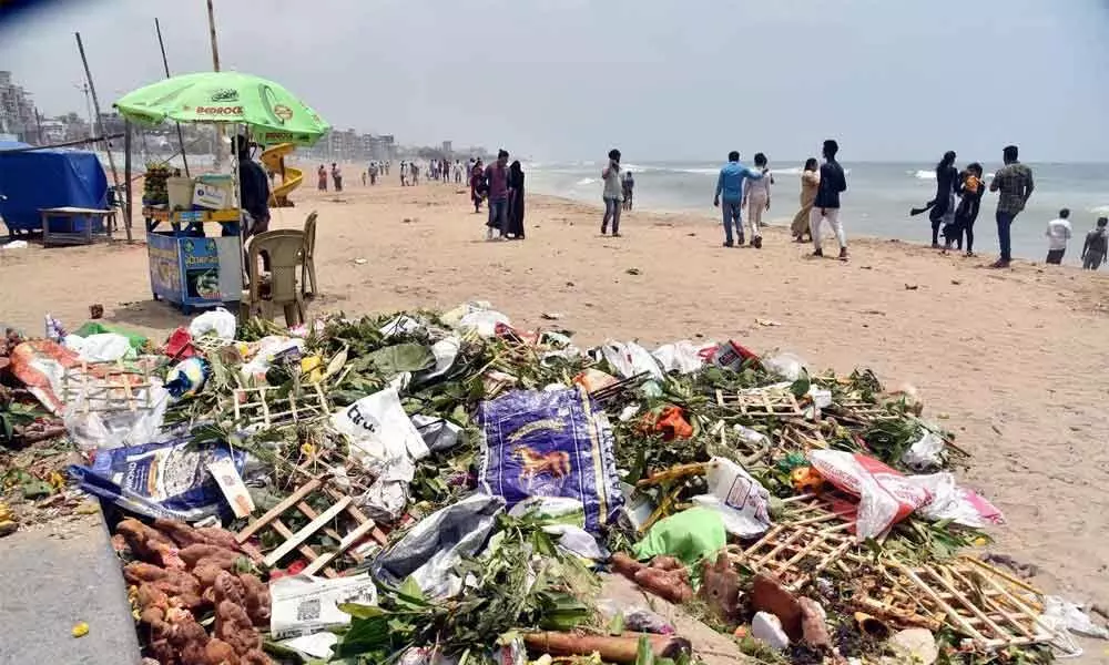 Heaps of puja material lie on the seashore after many carry out the immersion process in Visakhapatnam on Sunday