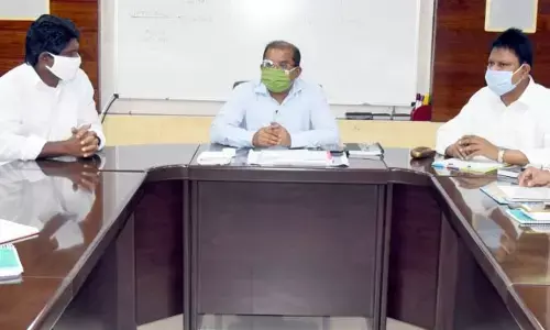 Collector Md Imtiaz holding a meeting with officials at his camp office in Vijayawada on Monday