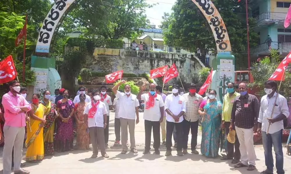 CPM leaders staging a protest at the corporation office in Khammam on Monday