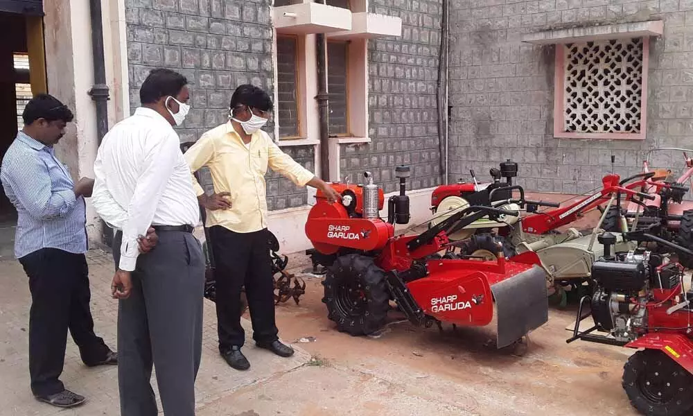 Agriculture engineer explaining about farm machinery on the institute premises to trainees in Anantapur on Monday