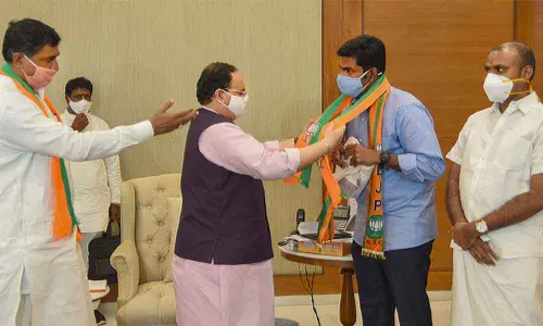 BJP national president J P Nadda greets former IPS officer K Annamalai as he joins BJP in New Delhi on Tuesday