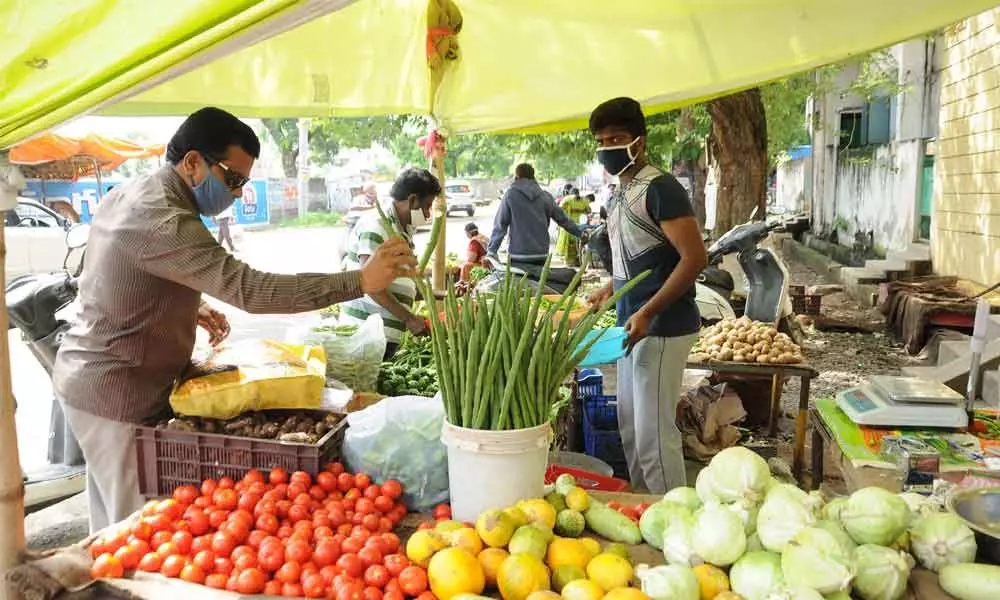 Consumers purchasing vegetables at BR Stadium in Guntur on Tuesday