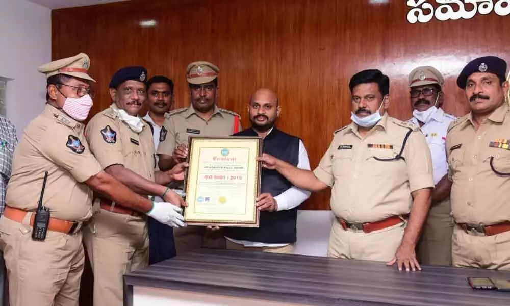 Krishna district Superintendent of Police M Ravindranath Babu and other officials receiving ISO certificate in Machilipatnam