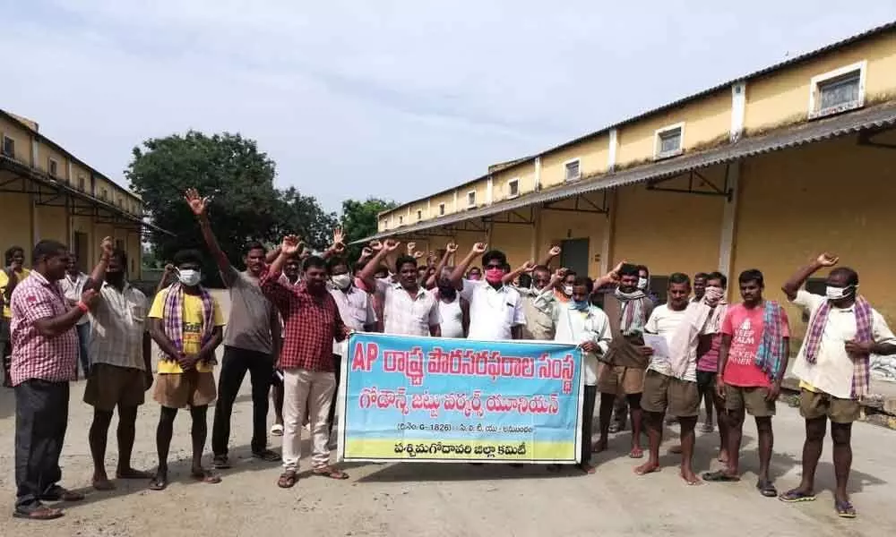 Hamalis staging protest in West Godavari district on Tuesday