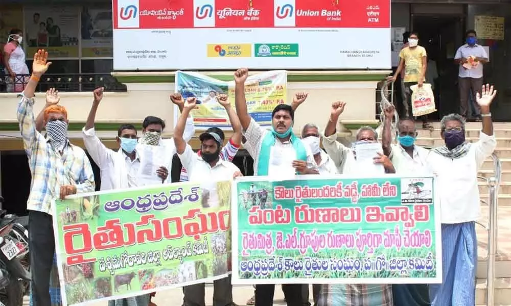 Tenant farmers staging a dharna in front of lead bank in Eluru on Tuesday