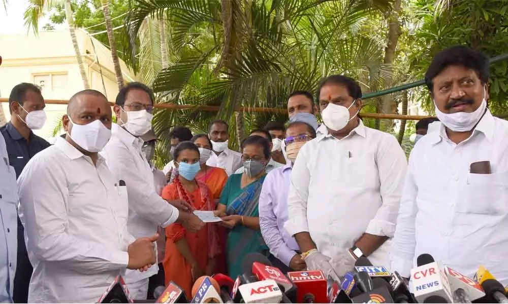 Dy CM and  Health Minister Alla Kalikrishna Srinivas along with Ministers Vellampalli Srinivas, Kodali Sri Venkateswara Rao handing over cheques of Rs 50 lakh each to the family members of victims in Swarna Palace fire accident in Vijayawada  on Tuesday