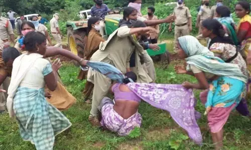 Tribal women preventing police and forest officers from removing crops