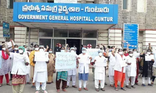 Nurses working on contract basis staging a protest at GGH in Guntur on Wednesday