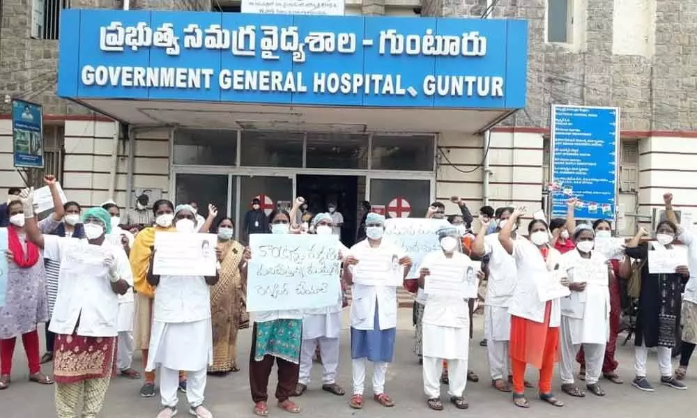 Nurses working on contract basis staging a protest at GGH in Guntur on Wednesday