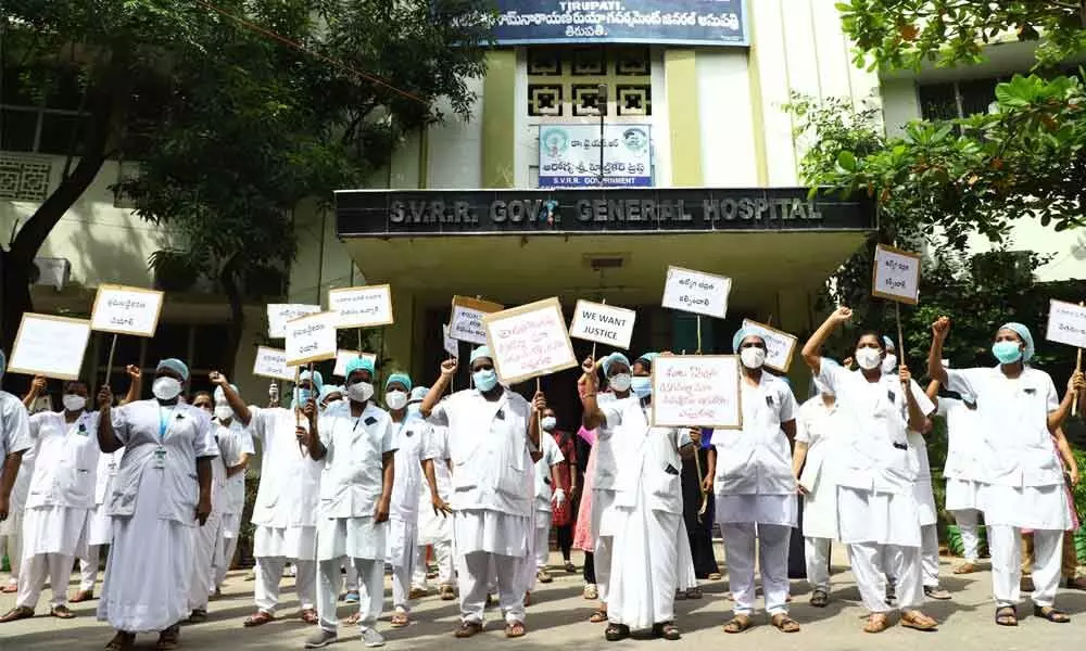 SV Ruia Hospital contract nurses staging a dharna in front of SVRR Government Hospital in Tirupati on Wednesday
