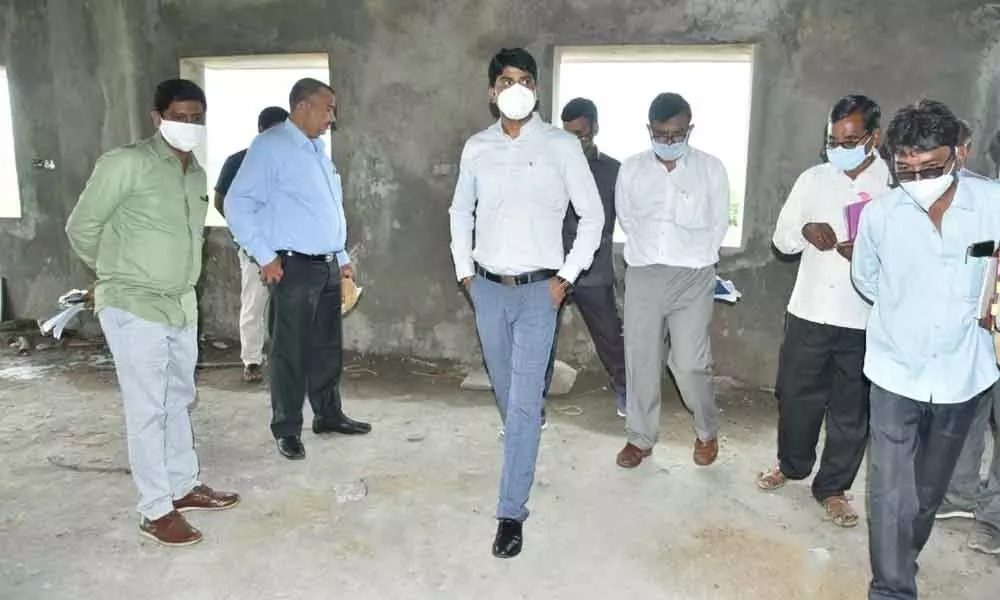 District Collector C Narayana Reddy enquiring the officials about the works of Telangana State Girls Minority Residential School complex under construction in Pandutarva village on Thursday