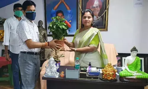 ITDA Project Officer R Kurmanath presenting a bouquet to Deputy Chief Minister P Pushpasreevani