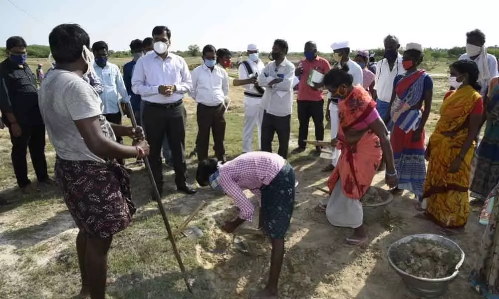 Collector K V N Chakradhara Babu interacting with the labourers at Nindali in Balayapalli mandal on Saturday