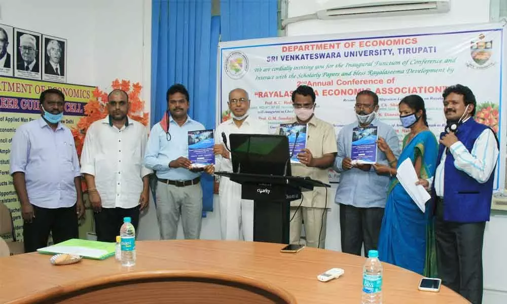 Prof M Chinnaswamy Naidu, Head, Department of Economics, RGUKT, releasing the souvenir of 2nd annual conference of Rayalaseema Economic Association in Tirupati on Saturday